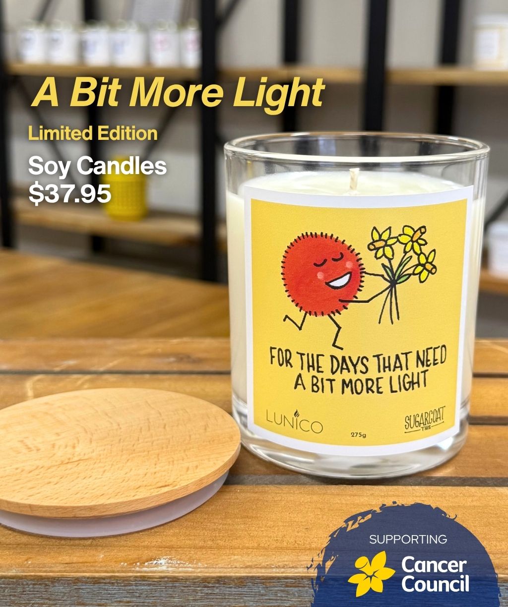 Candle with a yellow label on a wooden surface, featuring text and a price.